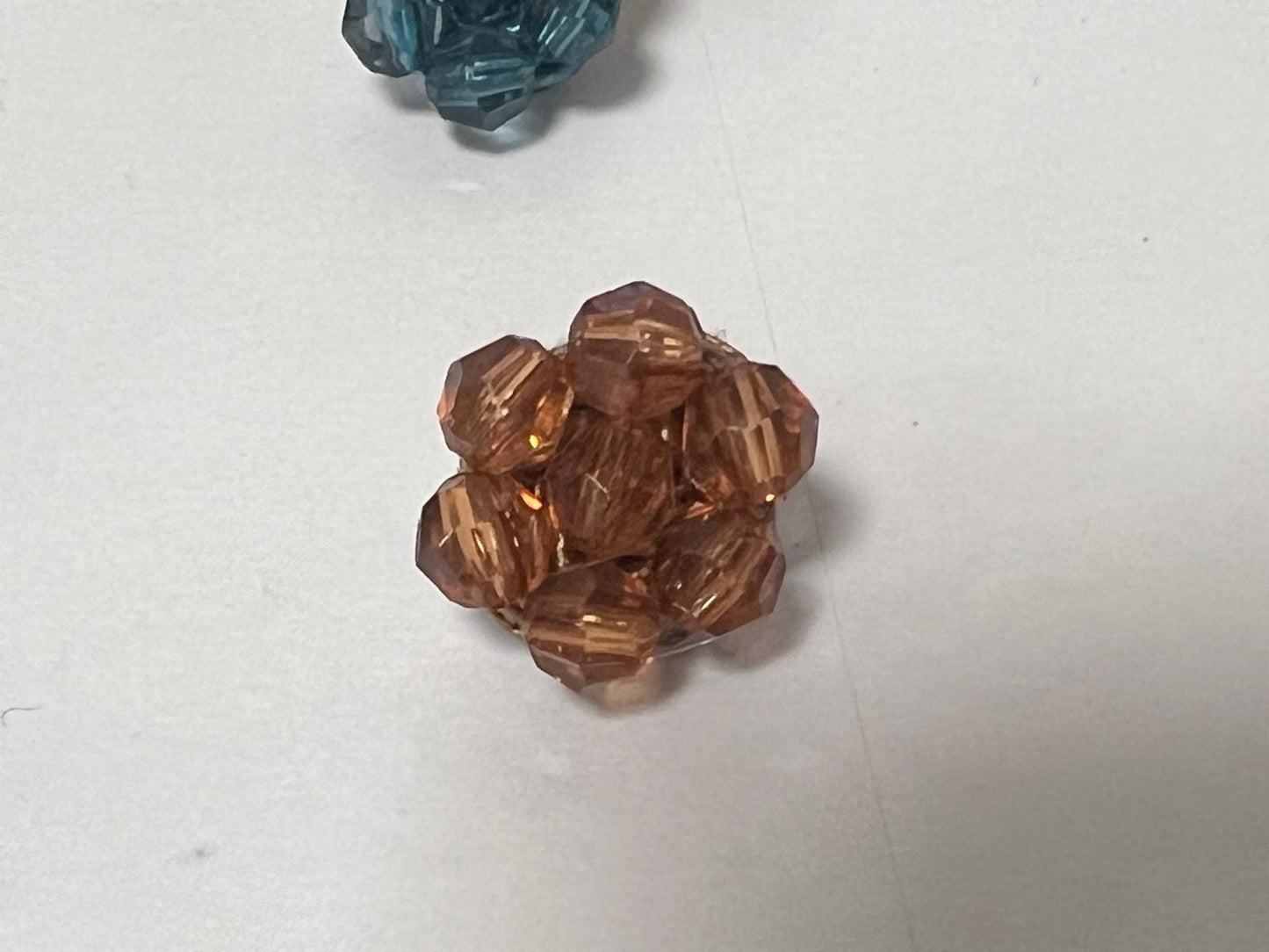 Beige faceted pearl button: elegance at the heart of couture