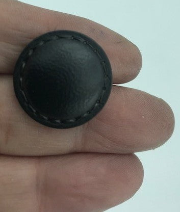 Black faux leather button in diameter 22 mm with saddler print to sew