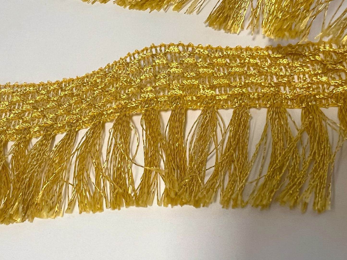 Gold Lamé Lurex Fringe 7 cm - Elegance and Shine by the Meter.