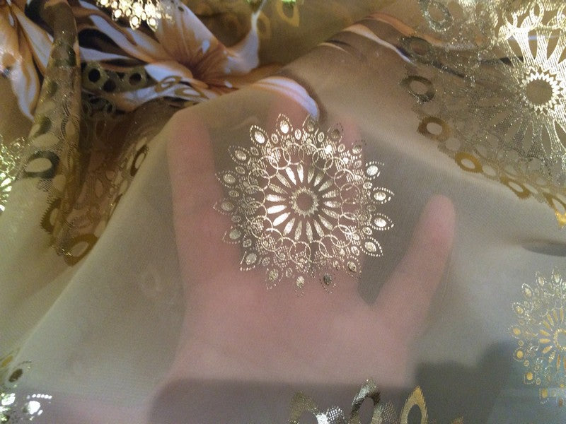 Polyester Muslin Fabric By The Meter In Salmon With Gold Flower Pattern.