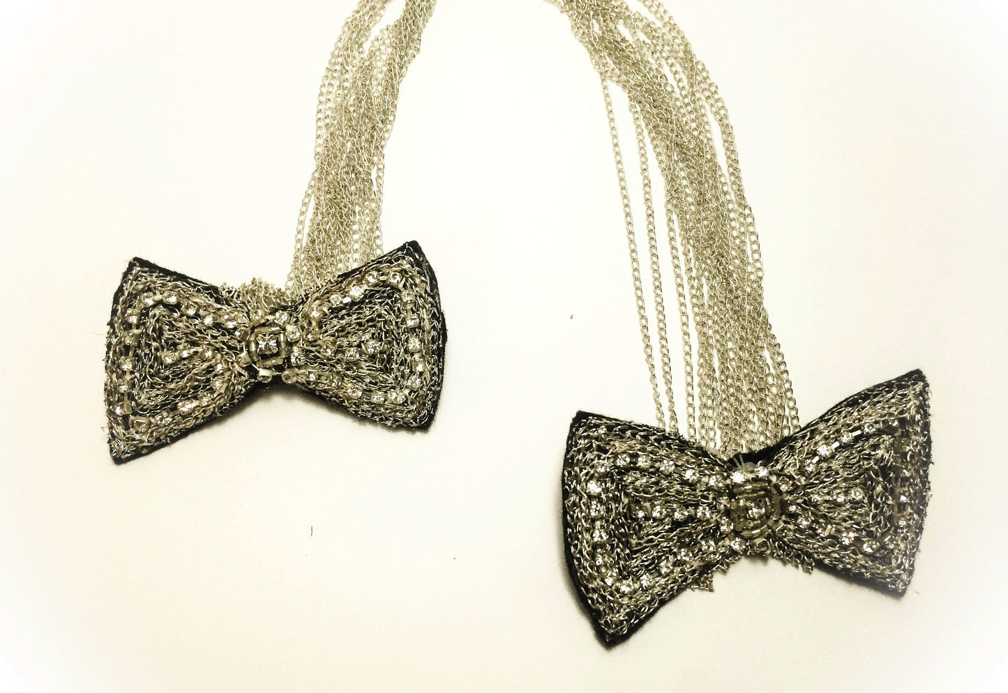 Black rhinestone brooch on silver chain, in the shape of butterfly knots