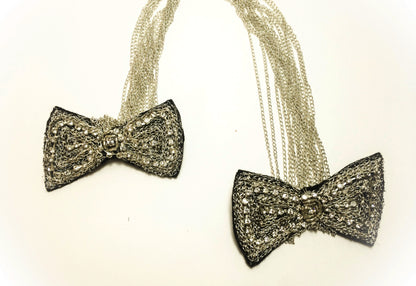 Black rhinestone brooch on silver chain, in the shape of butterfly knots