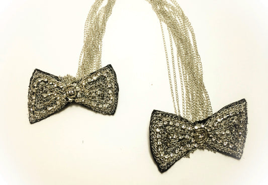 Black rhinestone brooch on silver chain, in the shape of butterfly knots