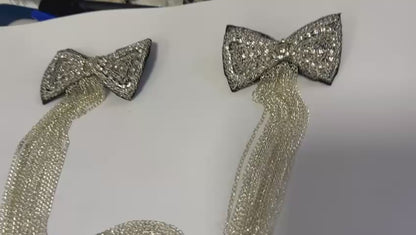 Black rhinestone brooch on silver chain, in the shape of butterfly knots