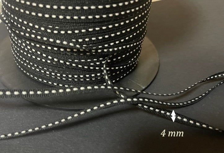 4 mm Grosgrain Ribbon in White Saddle Stitch on Black Background by the Meter for Sewing for Creative Hobbies and Decorations.