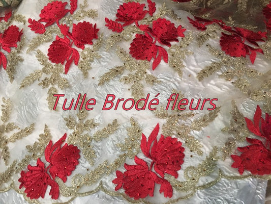Embroidered Couture Fabric on Flesh-Colored Mesh Tulle with Red and Gold Flower Patterns.